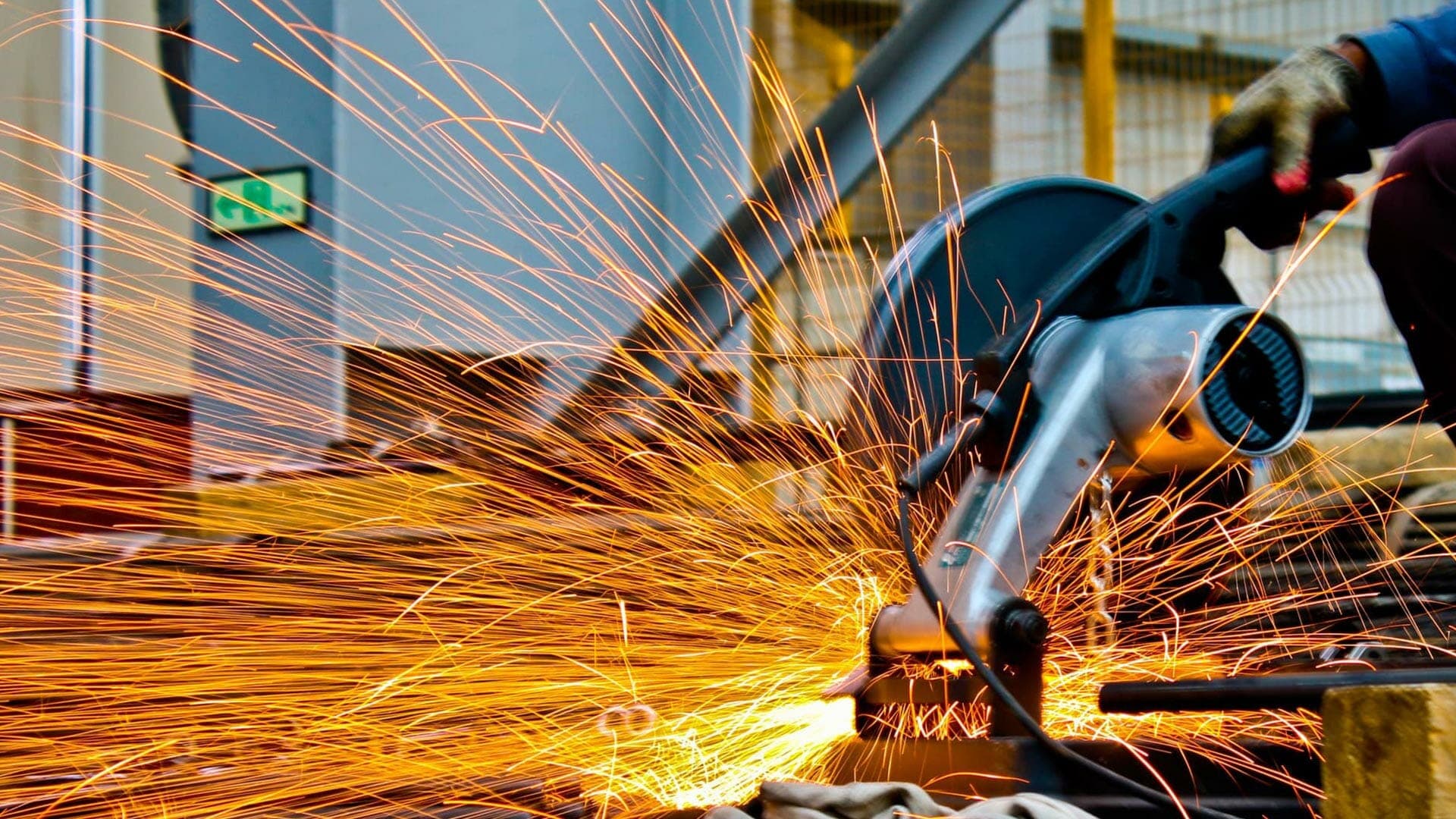 A worker operating a concrete saw